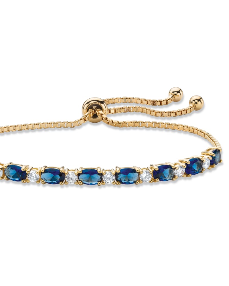 Front of a size 10 in 6.20 Cttw. Simulated Blue Sapphire and CZ Gold-Plated Bolo Bracelet 10" in Blue by PalmBeach Jewelry. | dia_product_style_image_id:333034